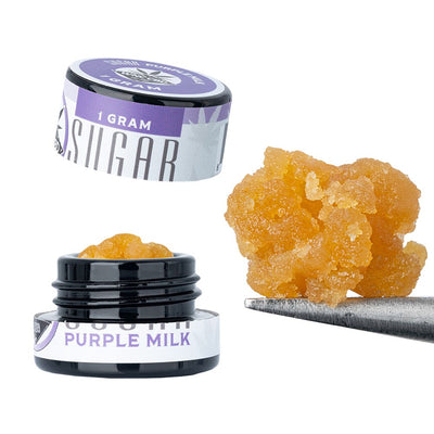 WNC CBD THCA Sugar in a container with a scoop, showcasing its rich amber color and texture.