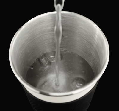 Water pouring into stainless steel cup of Puffco Cupsy Coffee Cup Water Pipe.