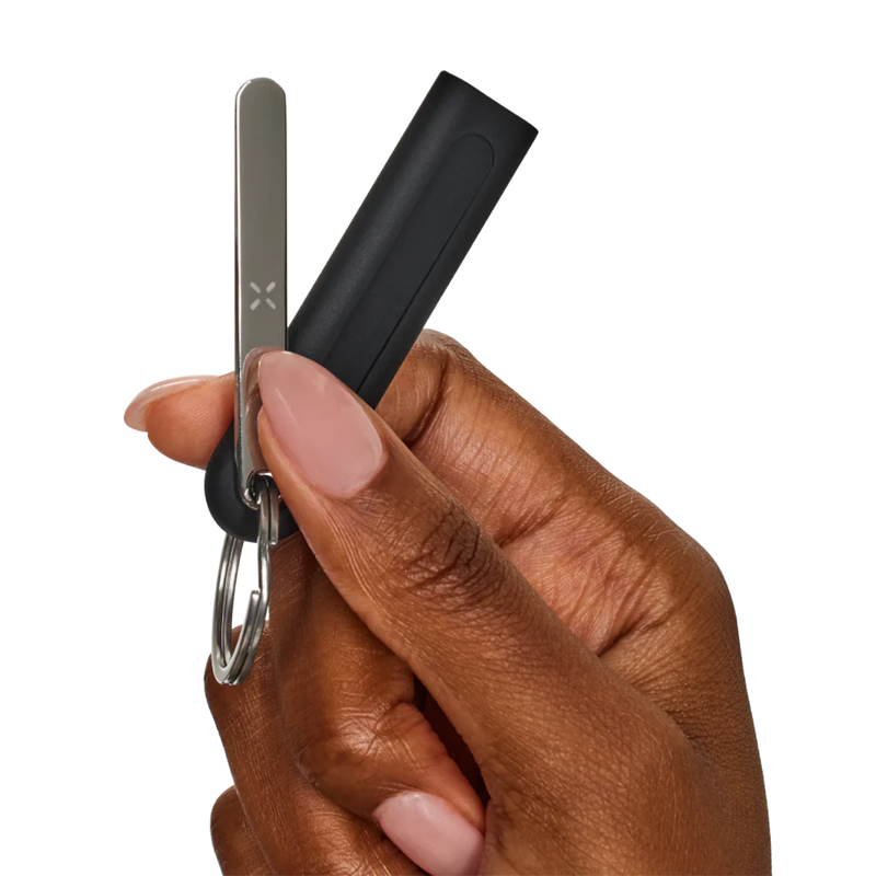 PAX Flow Vaporizer with Grip Sleeve Bundle components held in hand, featuring keychain and sleeve.